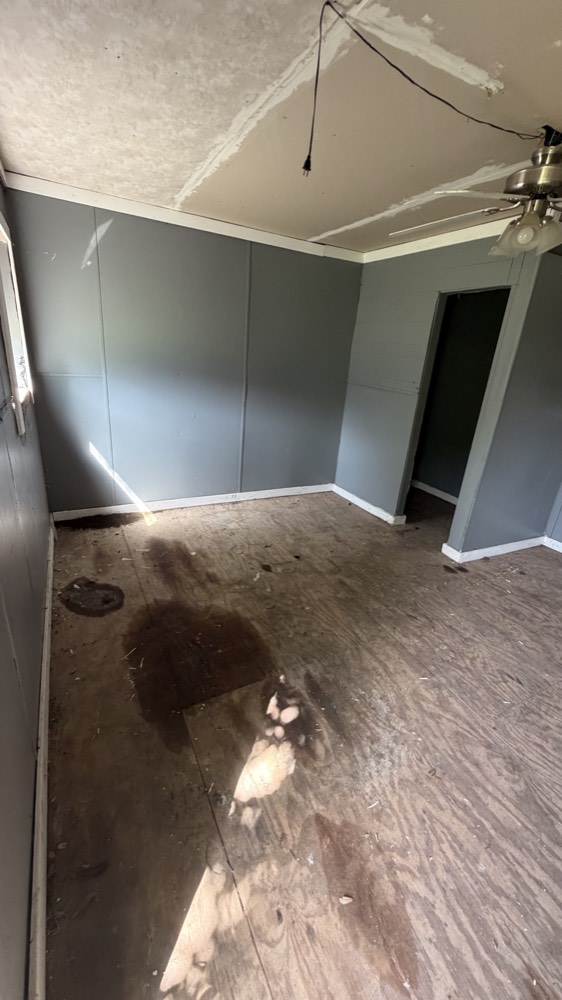 The same room cleared down to bare floor after Loredo Hauling