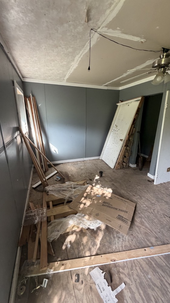 Interior room full of construction debris and old doors before clean-out