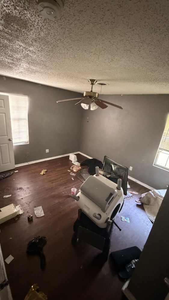 Room left full of trash and an old chair after a move-out